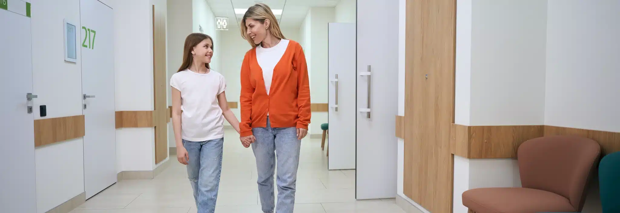 Parent and child walking through a healthcare clinic