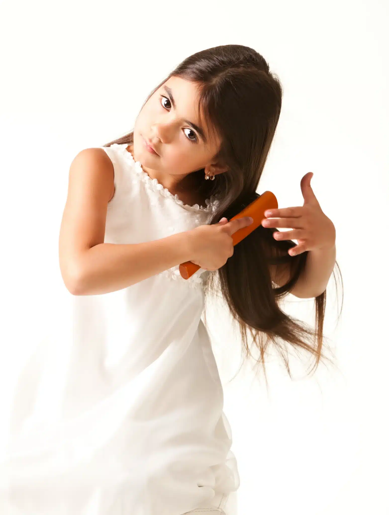 East Brunswick girl in white dress combing brown hair