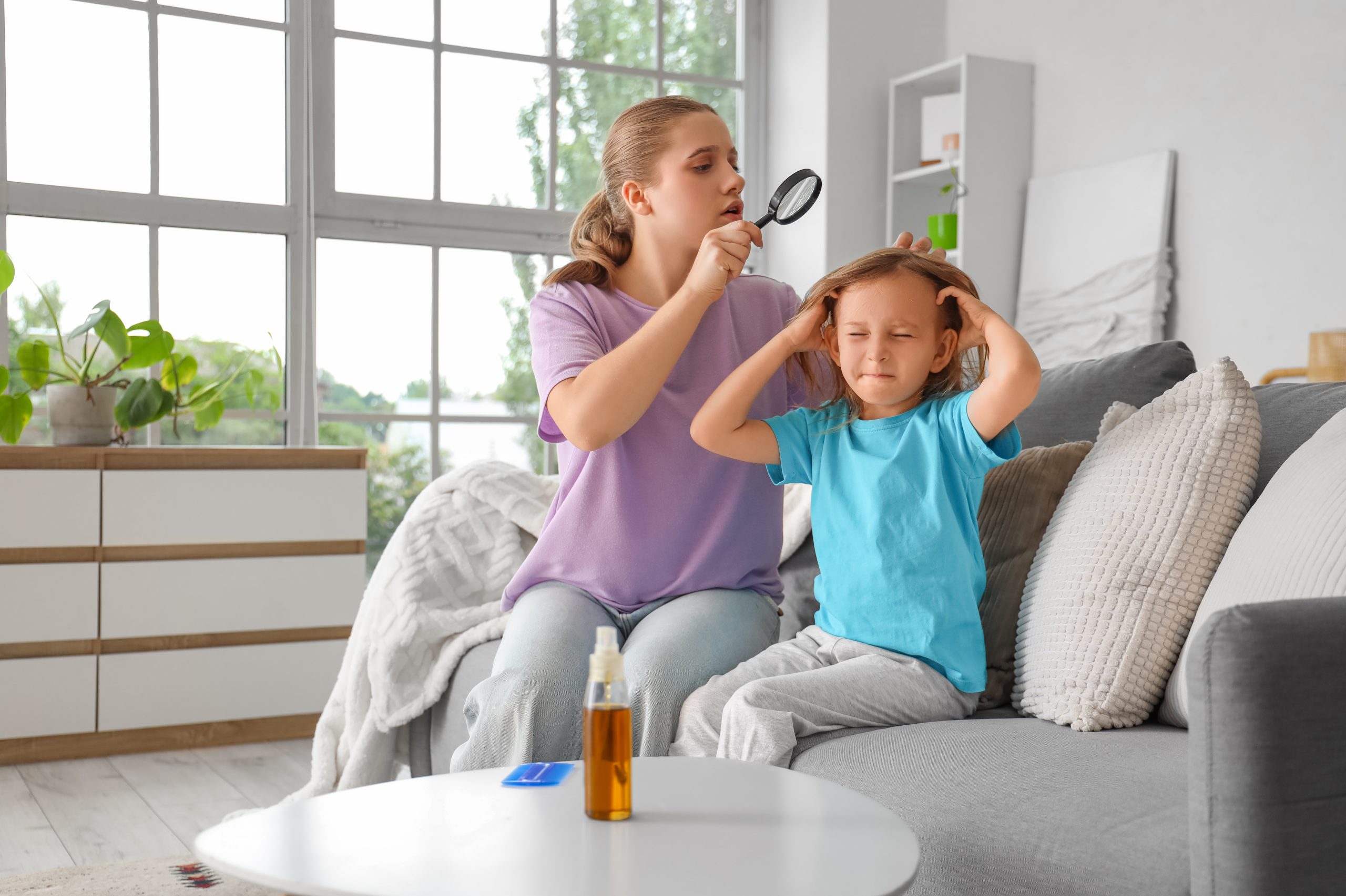 Parent inspecting a child hair during winter break