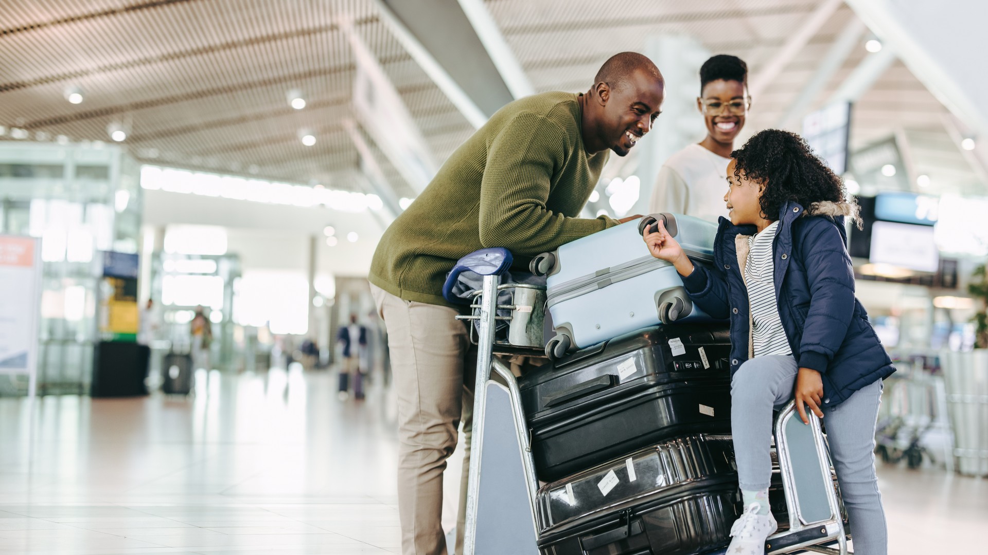 Family traveling with children and luggage at an airport