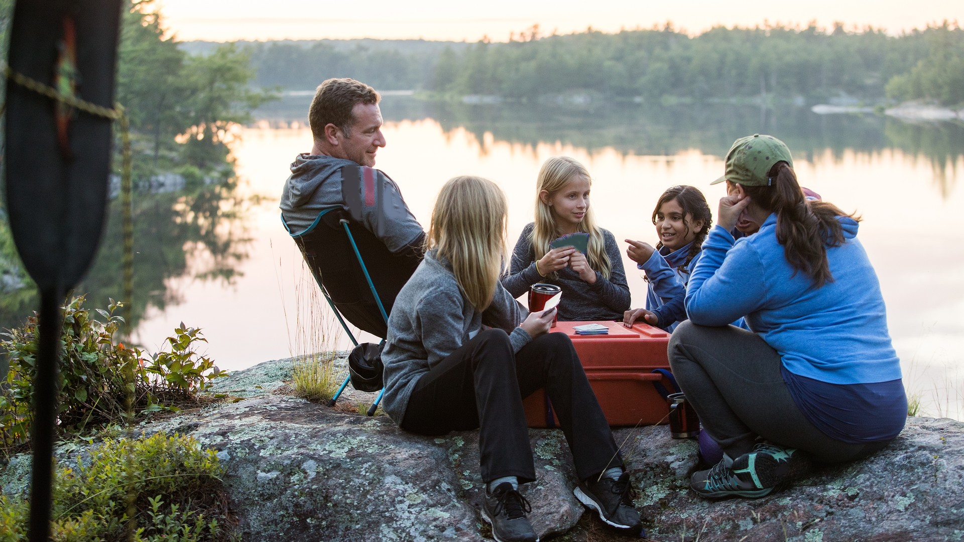 Children and counselors gathered at a lakeside summer camp