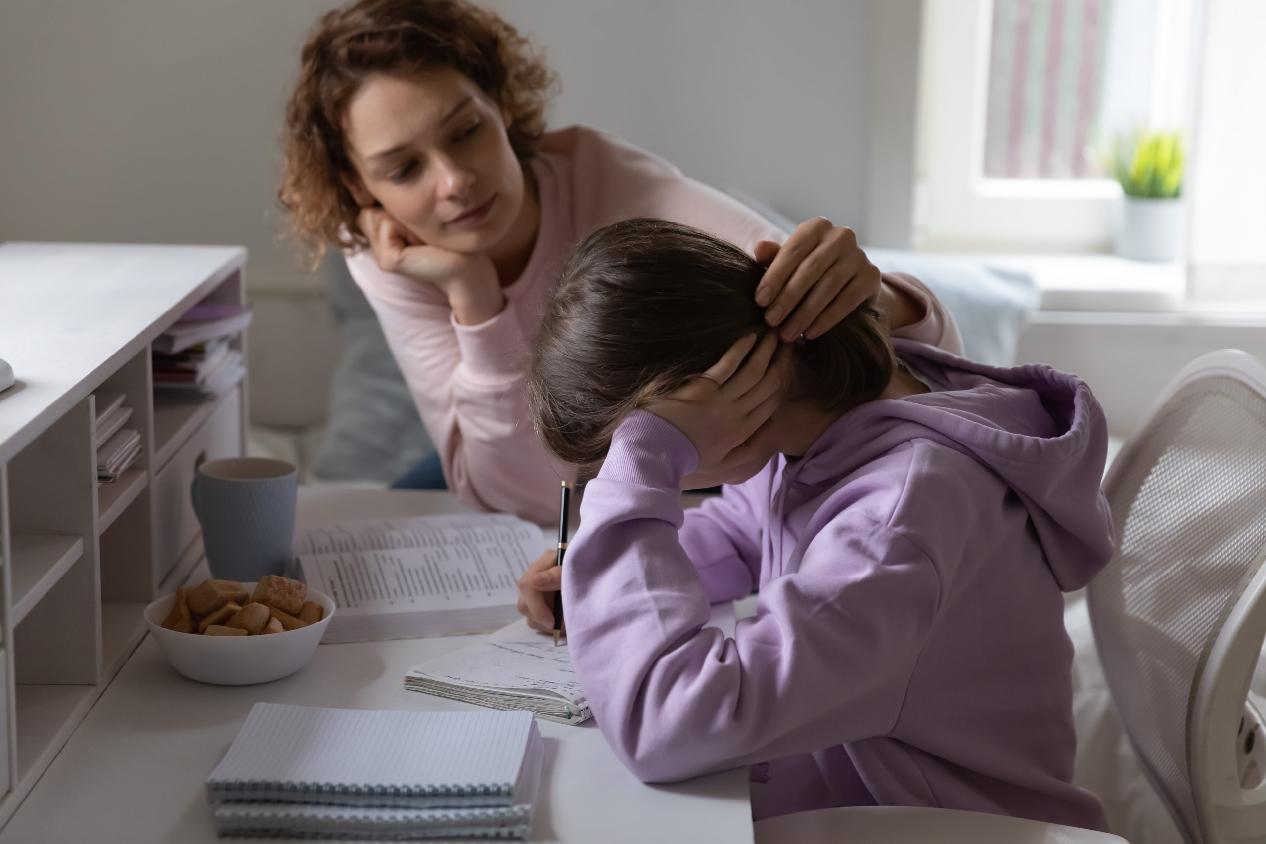 Mother comforting a tired child at home
