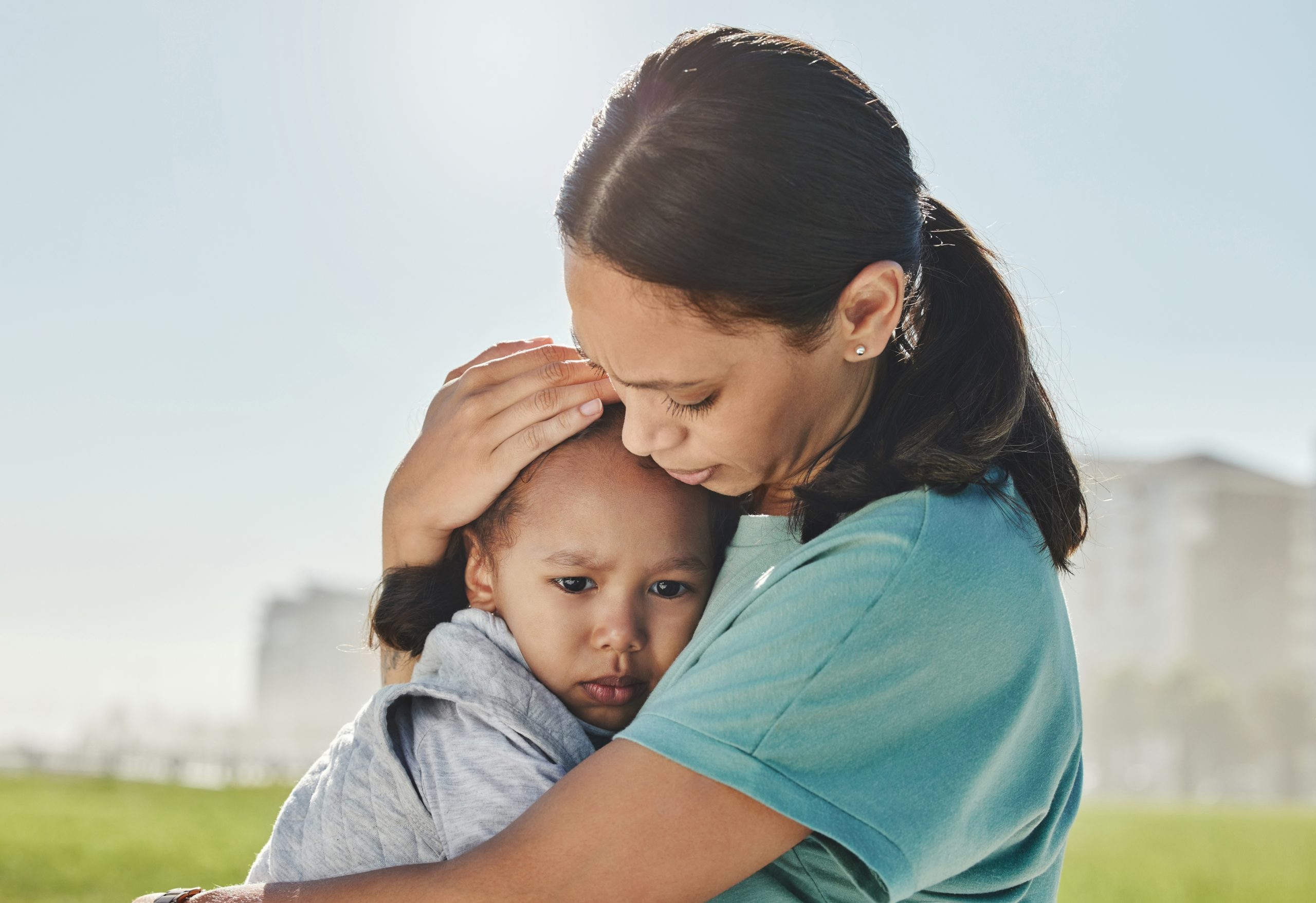 Parent comforting a sad child to reduce shame and worry